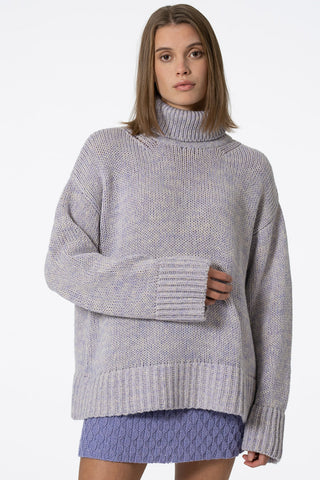 Model wearing lilac oversized Merino Turtleneck sweater by Dinadi. 