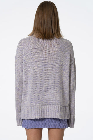 Back view of model wearing lilac oversized Merino Turtleneck sweater by Dinadi. 