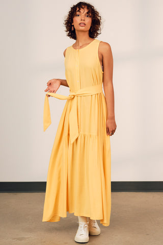 Model wearing yellow belted Alethea maxi dress by Jennifer Glasgow. 