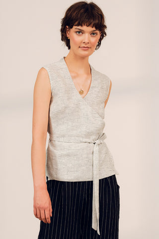 Woman wearing linen blend grid print wrap Damia tank top by Jennifer Glasgow. 
