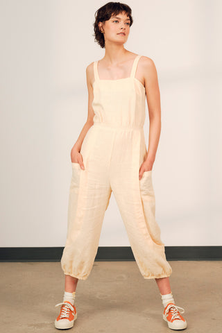 Model wearing light peach OEKO-TEK linen Danu jumpsuit by Jennifer Glasgow. 