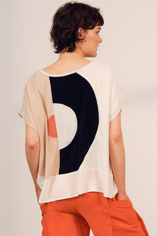 Back view of woman wearing cream and black colour blocked Iris top by Jennifer Glasgow. 