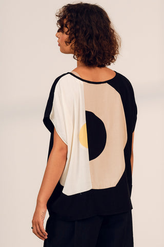 Back view of woman wearing black and cream colour blocked Iris top by Jennifer Glasgow. 