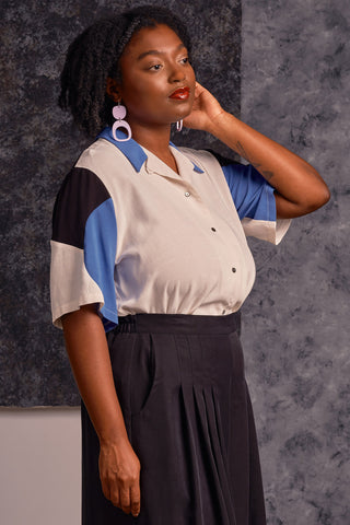 Side view of model wearing cream, black and cornflower blue colour blocked button up Mavis shirt by Jennifer Glasgow.