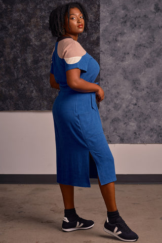 Side view of model wearing midi length royal blue and tan colour blocked Meri dress by Jennifer Glasgow. 