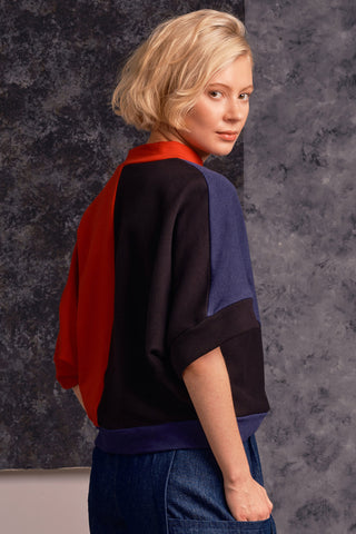 Model wearing navy blue, black and orange colour blocked Razia Sweater by Jennifer Glasgow. 