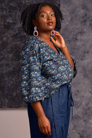 Side view of model wearing blue floral print Sakima Top by Jennifer Glasgow. 