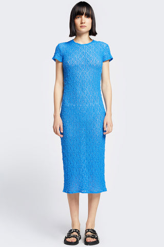 Woman wearing blue knit short sleeve midi Trove dress by Kloke. 
