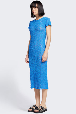 Woman wearing blue knit short sleeve midi Trove dress by Kloke. 