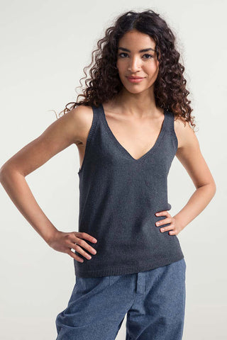 Woman wearing dark grey recycled + organic cotton blend v-neck Clara tank top by Rifo. 