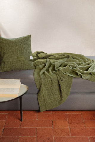 Green recycled cashmere cable knit Elide blanket by Rifo. 