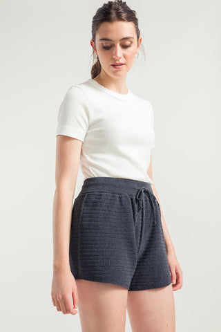 Woman wearing grey sporty recycled cotton / organic cotton blend Stella Shorts by Rifo. 