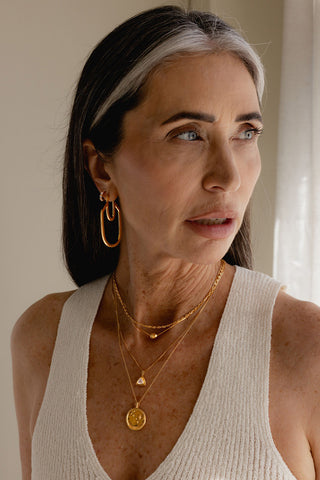 Model wearing Sarah Mulder gold Miranda Earrings. 
