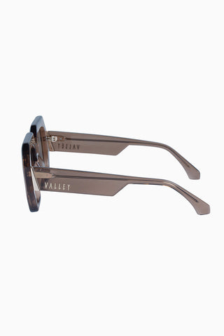 Valley Monolith sunglasses in transparent mocha with gold metal trim and light brown lenses. 