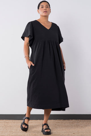 Model wearing black oversized Ayla Maxi Dress by Jennifer Glasgow. 