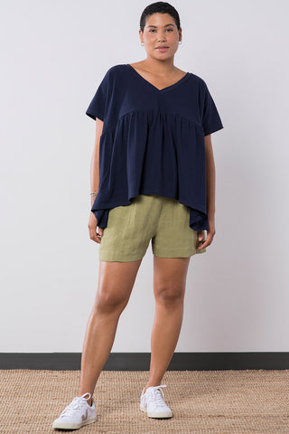 Model wearing sage OEKO-TEK linen blend Leda shorts by Jennifer Glasgow. 
