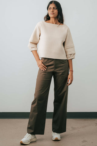 Model wearing organic cotton Jennifer Glasgow Moray pants in olive. 