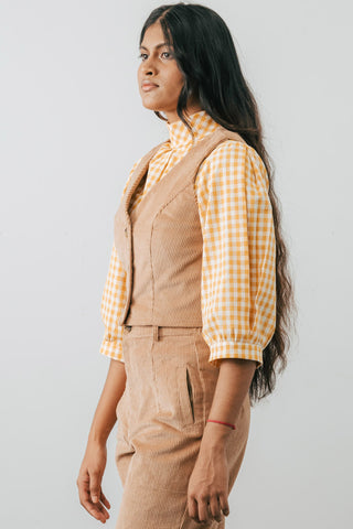 Model wearing beige organic corduroy Omura Vest by Jennifer Glasgow. 