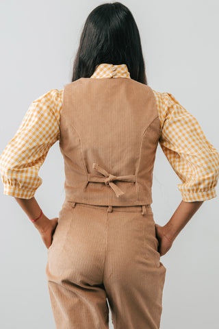 Back view of model wearing beige organic corduroy Omura Vest by Jennifer Glasgow. 