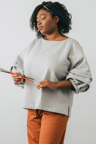 Model wearing grey organic cotton Pearl Sweater by Jennifer Glasgow. 
