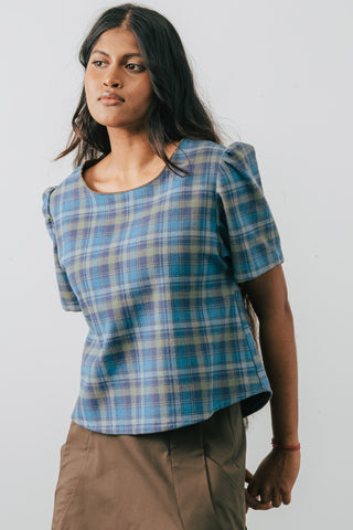 Model wearing Jennifer Glasgow Samudra blue plaid blouse in GOTS certified organic cotton.