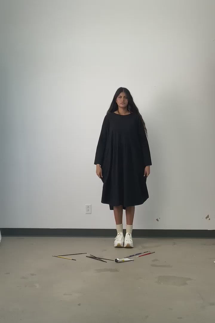 Video of model wearing Jennifer Glasgow Mazu dress in black organic cotton. 