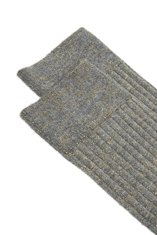 Close-up of a pair of grey and gold lurex rib knit socks on white background. 