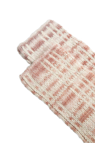 Close-up of pink and cream rib knit socks on white background. 