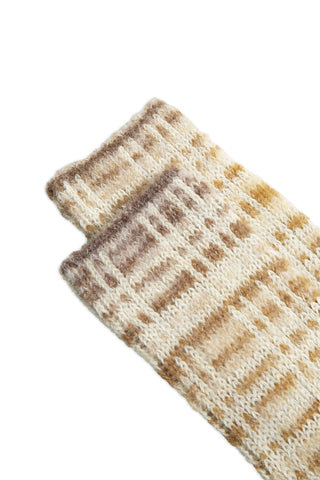 Close-up of taupe and cream rib knit socks on white background. 