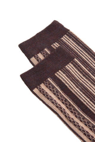 Close-up of a pair of burgundy and cream stripe pattern socks. 