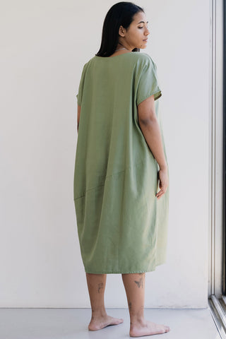 Back view of model wearing green oversized Organic Shape Dress by Ablesia. 