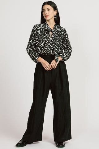 Model wears black dot print long sleeve Blaire blouse by Allison Wonderland. 