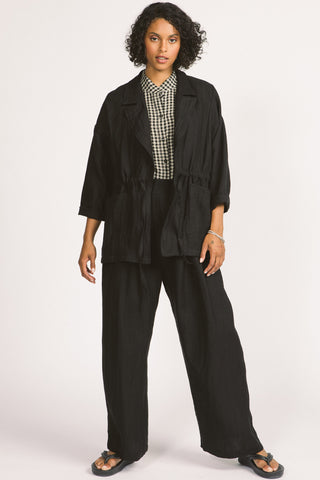 Woman wearing loose fitting black linen Greer blazer by Allison Wonderland. 