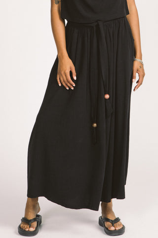Woman wearing black maxi length Oriana Skirt by Allison Wonderland. 