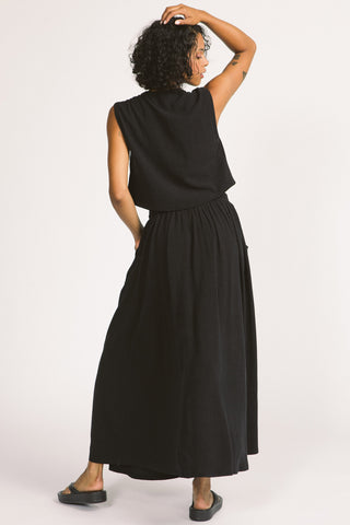 Back view of woman wearing black maxi length Oriana Skirt by Allison Wonderland. 