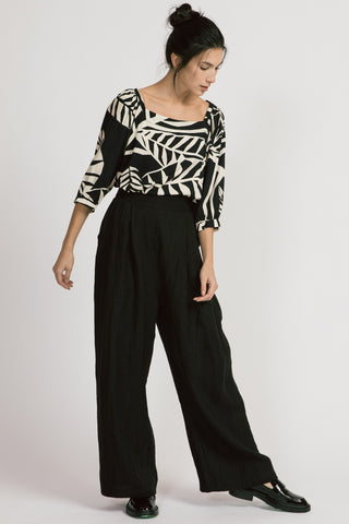 Model wearing black leaf print Theda blouse by Allison Wonderland. 