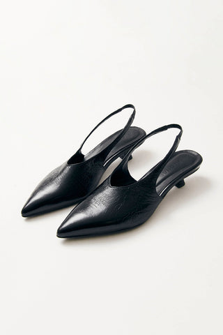 Black leather kitten heel sling back pumps on white background. 