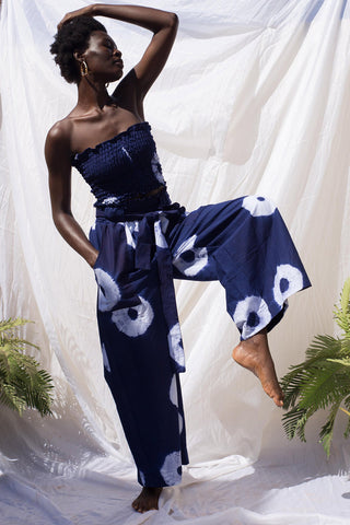 Woman wearing wide leg indigo wax print Volta pants and matching tube top by Batik Boutik.