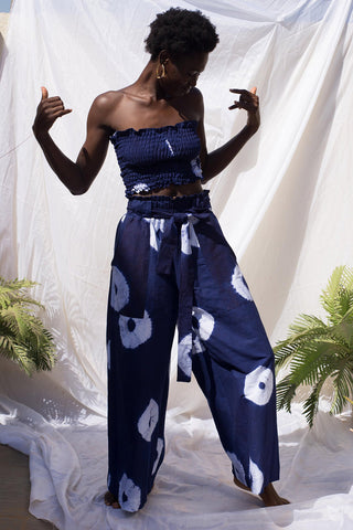 Woman wearing wide leg indigo wax print Volta pants and matching tube top by Batik Boutik.