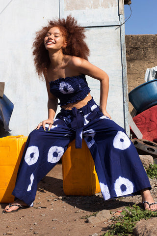 Woman wearing wide leg indigo wax print Volta pants and matching tube top by Batik Boutik