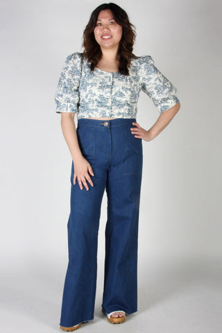 Woman wearing high waist denim Bloodfool pants by Birds of North America. 