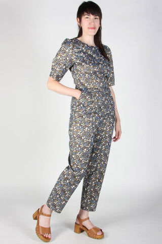 Model wearing short sleeve Brambling Jumpsuit in Countess print by Birds of North America. 