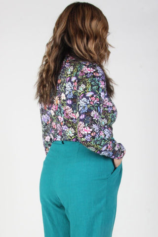 Back view of model wearing Deep Afternoon Garden print long sleeve mock neck Nuncie top by Birds of North America. 