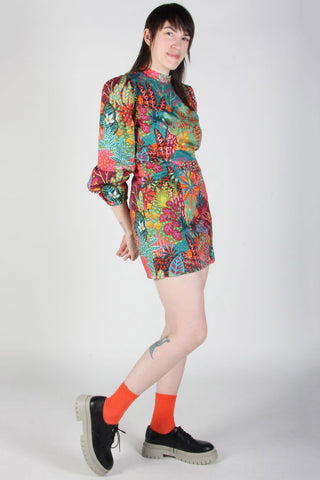 Model wearing Shy Menagerie print Nuctale dress by Birds of North America. 