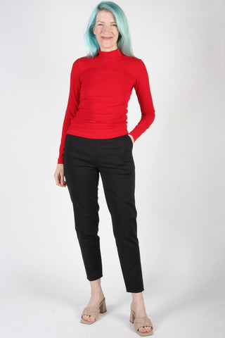 Woman wearing black cropped tapered leg Tern pants by Birds of North America. 