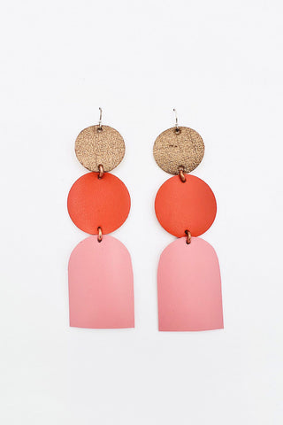 Leather earrings with gold and orange circles and pink arch made from leather. 