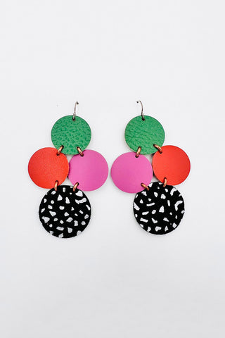 Recycled leather earrings with green, orange, pink and black circles. 