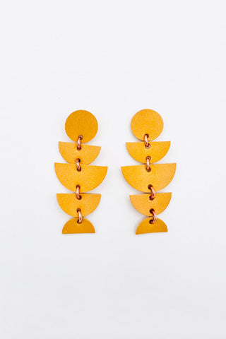 Yellow dangle earrings made from various leather shapes. 