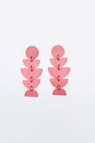 Pink dangle earrings made from various leather shapes. 