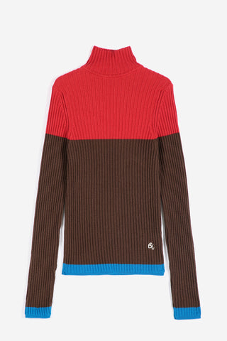 A color-blocked ribbed turtleneck sweater with a bright red upper chest and shoulders, a dark brown lower body and sleeves, a bright blue hem and cuffs, and a small white embroidered logo on the bottom right.